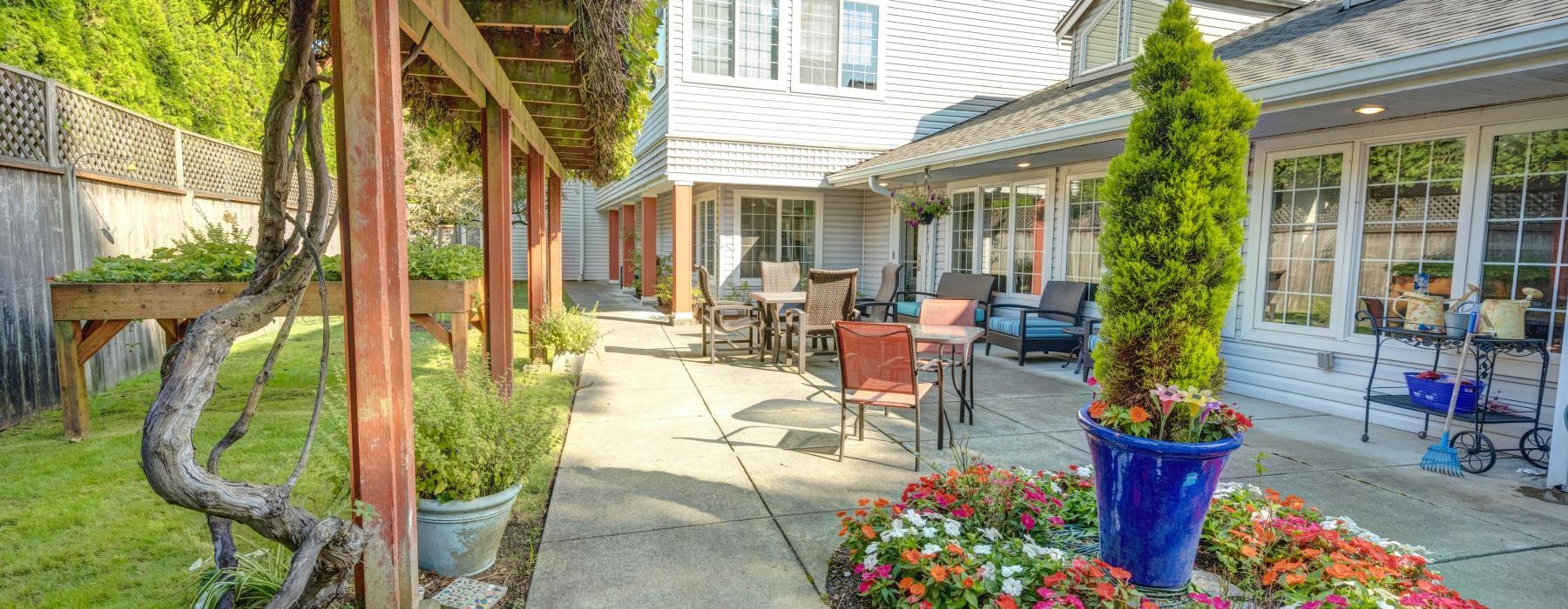 a backyard with a patio and a flower bed