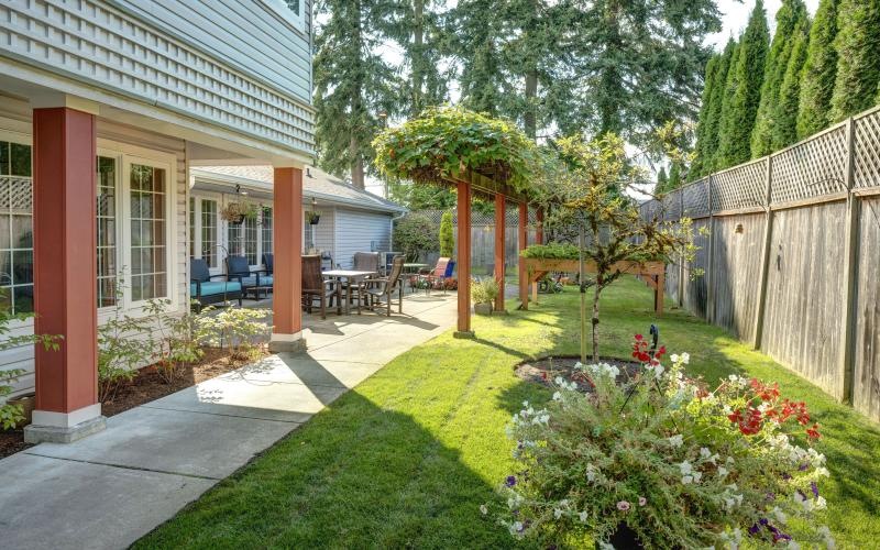 a backyard with a fence and trees