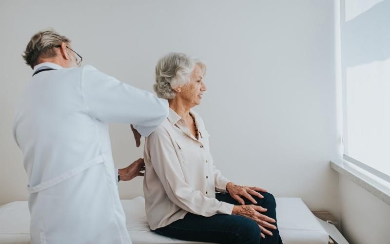 a doctor checking on an older woman